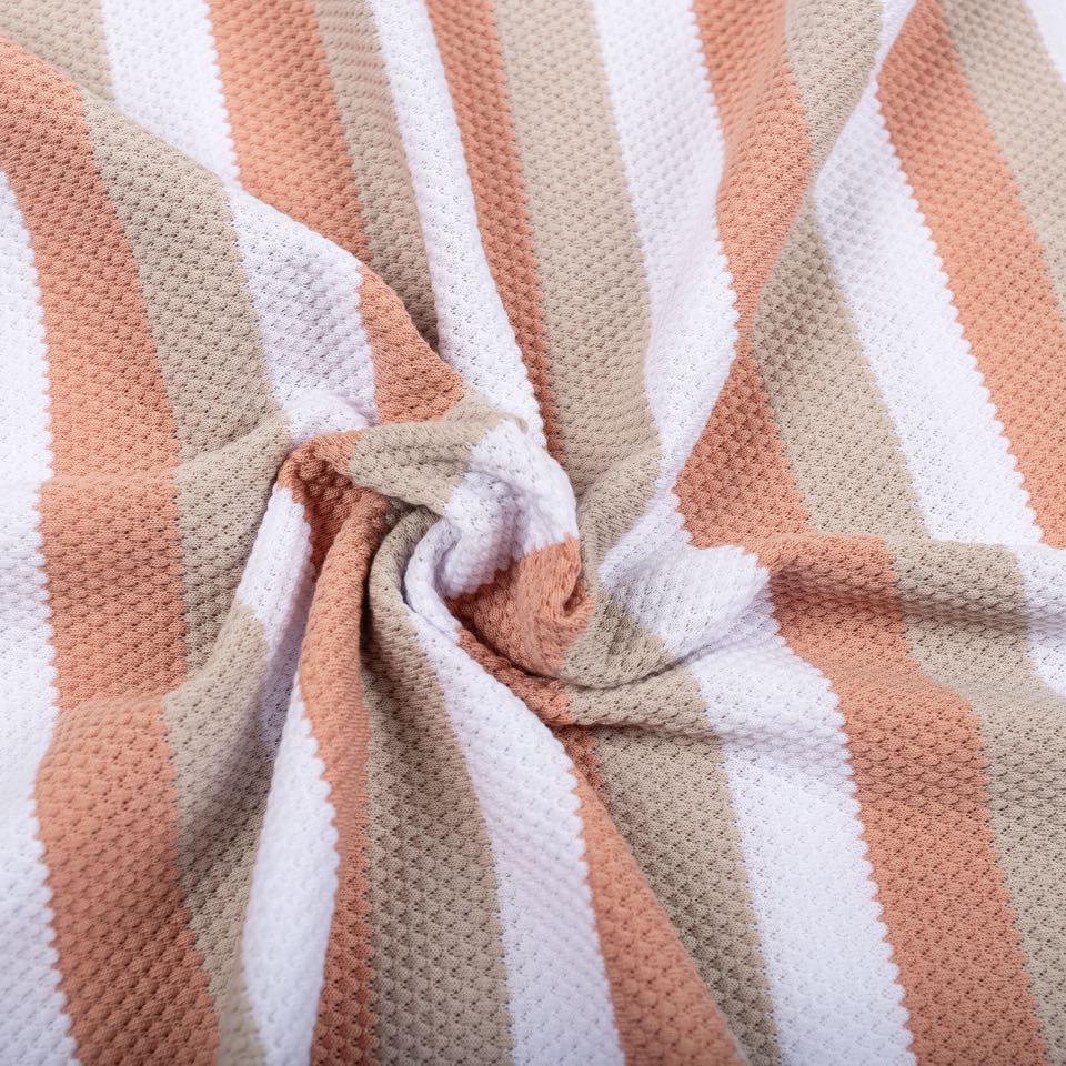 Honeycomb pique in peach, sand and white stripes, twisted into a swirl.